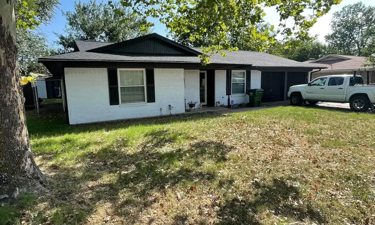 Professional roofing crew working on a residential roof in Maumee